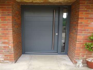 OXTON , WIRRAL. Installation of a Hamburg Red Grandis hardwood timber door and frame, fitted with a 1800 Stainless steel pull handle inside and out with pull shot locking 